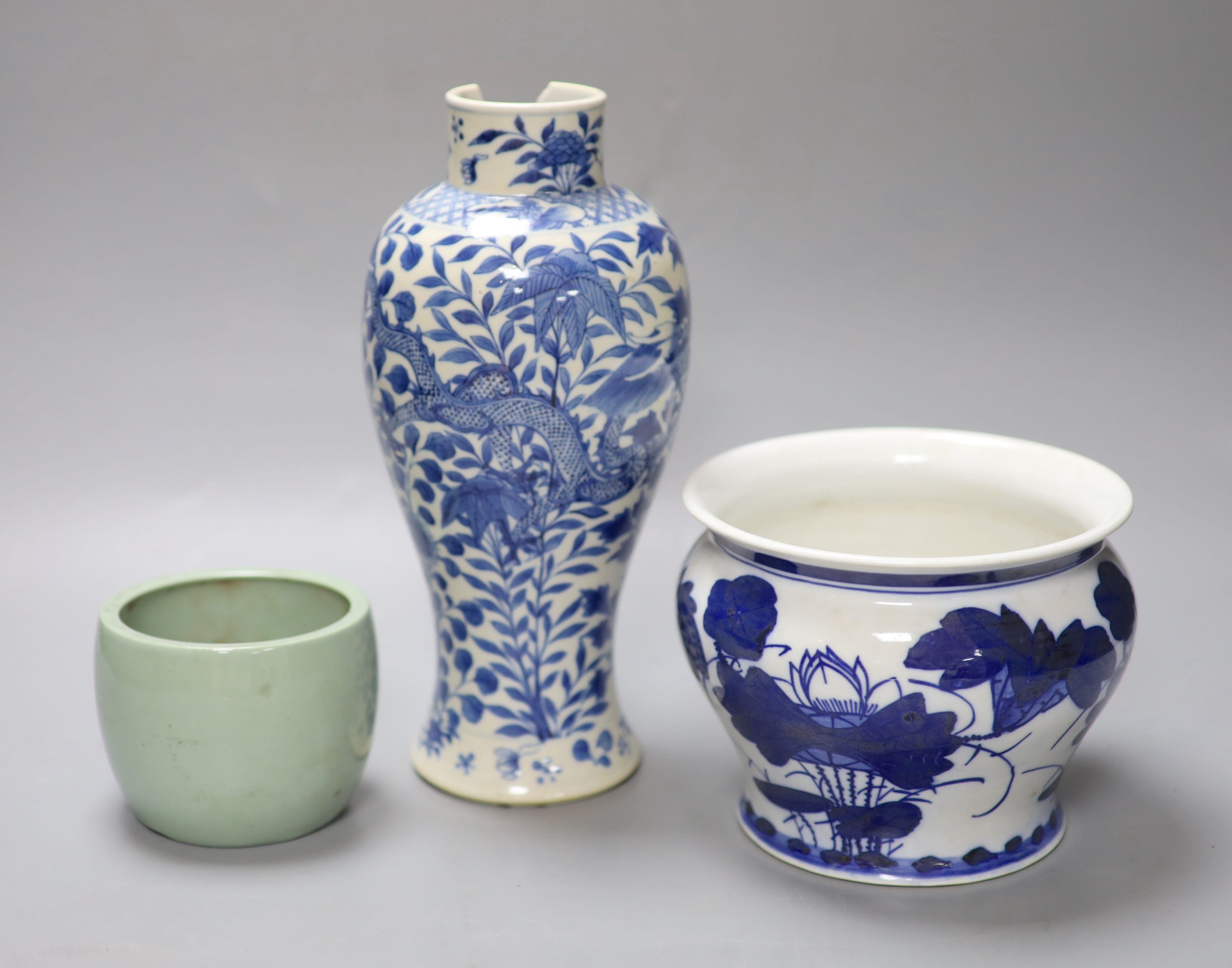 A Chinese blue and white dragon vase with Kangxi mark, together with a blue and white jardiniere and a celadon glazed bowl